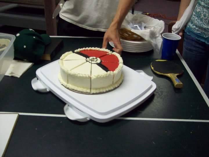 Rick cuts a Poké Ball cake baked by their pastry chef friend, Monique