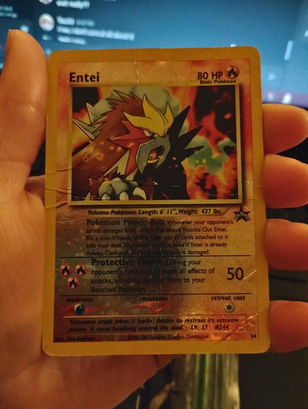 A photograph of Tallax’s Entei promo card