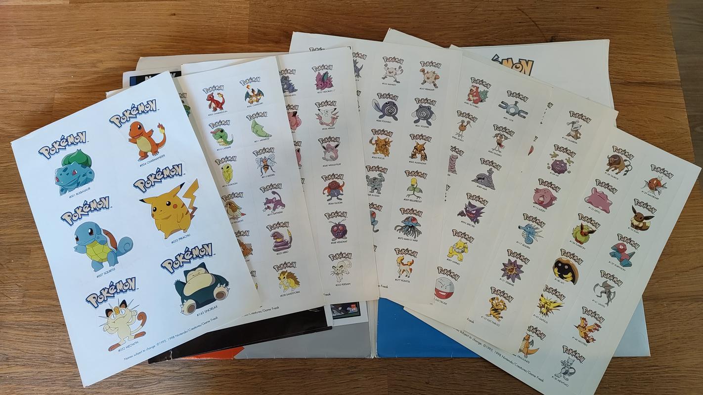 A photograph of sticker sheets containing all 150 Pokémon. Many names were not finalised at the time, which is mentioned at the bottom of each page