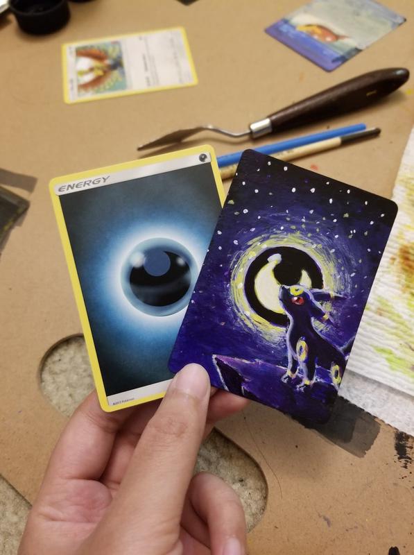 Tiff’s custom full art card of Umbreon, painted on a Darkness Energy card