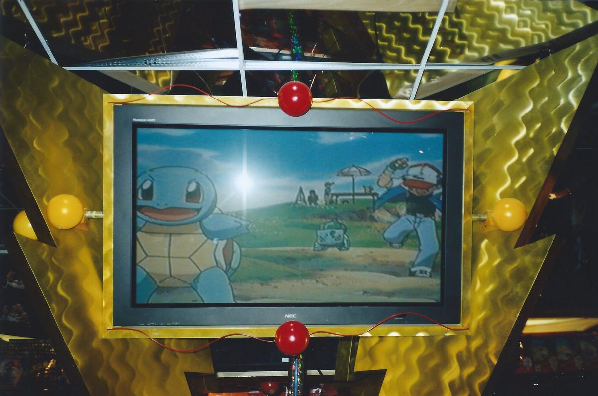 A photograph of a screen, which played Pokémon: The First Movie, at FAO Schwarz, taken between November/December 2000